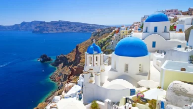 White churches blue domes the coastline Santorini Greece DNX